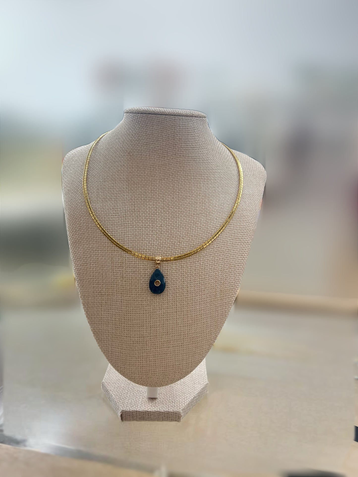 Gold Omega Necklace With Blue Tear Drop